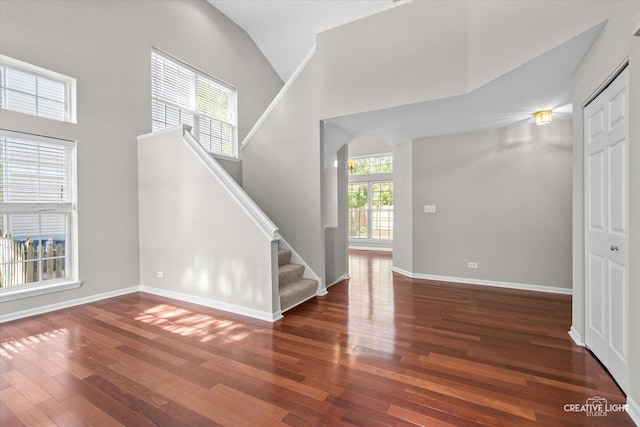 1207 Pennsbury Ln, Aurora, IL 60502 - foyer entrance with hardwood / wood-style flooring, stairway, baseboards, and high vaulted ceiling