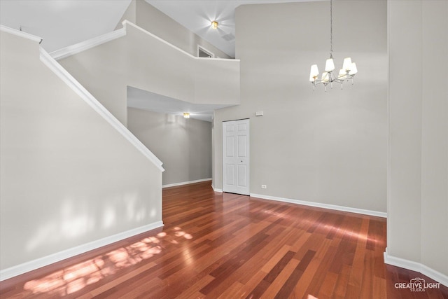 1207 Pennsbury Ln, Aurora, IL 60502 - spare room with a chandelier, wood finished floors, baseboards, and a high ceiling