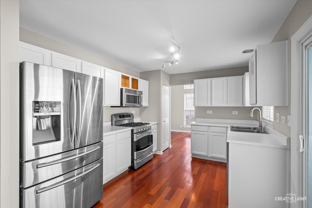 1207 Pennsbury Ln, Aurora, IL 60502 - kitchen with appliances with stainless steel finishes, a sink, light countertops, and dark wood-style floors