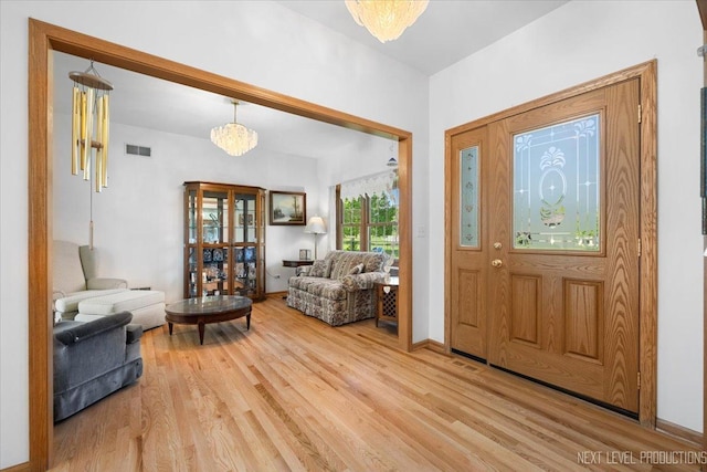 46W306 Woodview Pkwy, Hampshire, IL 60140 - entryway featuring light wood-type flooring, baseboards, and a chandelier