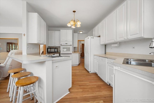 46W306 Woodview Pkwy, Hampshire, IL 60140 - kitchen with light wood-type flooring, a sink, a chandelier, and white cabinetry