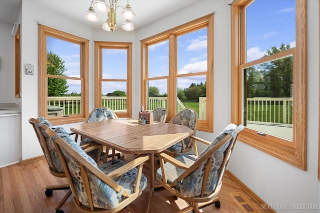 46W306 Woodview Pkwy, Hampshire, IL 60140 - dining area featuring a chandelier, baseboards, and healthy amount of natural light