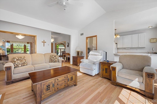 46W306 Woodview Pkwy, Hampshire, IL 60140 - living room featuring healthy amount of natural light, vaulted ceiling, light wood-type flooring, ceiling fan, and a chandelier