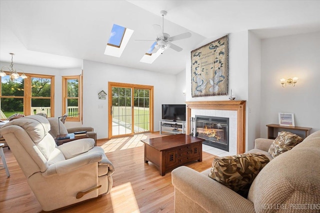46W306 Woodview Pkwy, Hampshire, IL 60140 - living area featuring vaulted ceiling, light wood finished floors, plenty of natural light, a skylight, and a ceiling fan