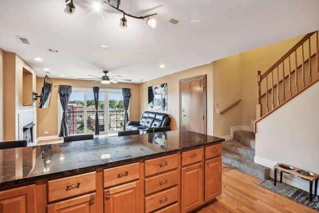5652 W 63rd St Unit 3E, Chicago, IL 60638 - kitchen featuring visible vents, baseboards, open floor plan, light wood-type flooring, and a ceiling fan