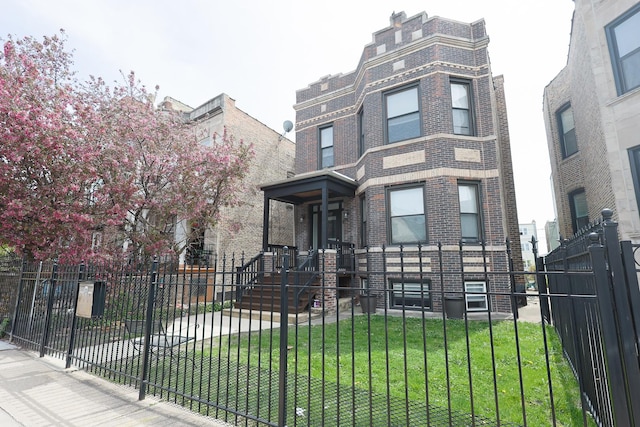 3237 W Cortez St, Chicago, IL 60651 - second empire-style home with brick siding, a fenced front yard, and a front yard