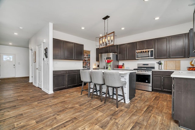 1825 Spencer Way, Shorewood, IL 60404 - kitchen featuring dark wood finished floors, a breakfast bar area, stainless steel appliances, and dark brown cabinets