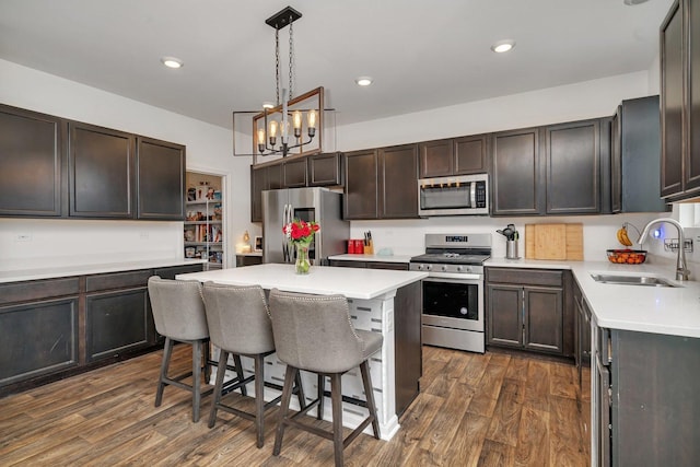 1825 Spencer Way, Shorewood, IL 60404 - kitchen with dark wood finished floors, appliances with stainless steel finishes, a kitchen bar, and a sink