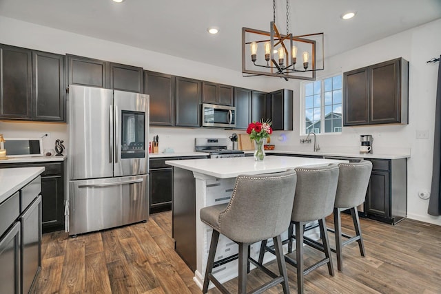 1825 Spencer Way, Shorewood, IL 60404 - kitchen featuring a kitchen bar, light countertops, a notable chandelier, and appliances with stainless steel finishes