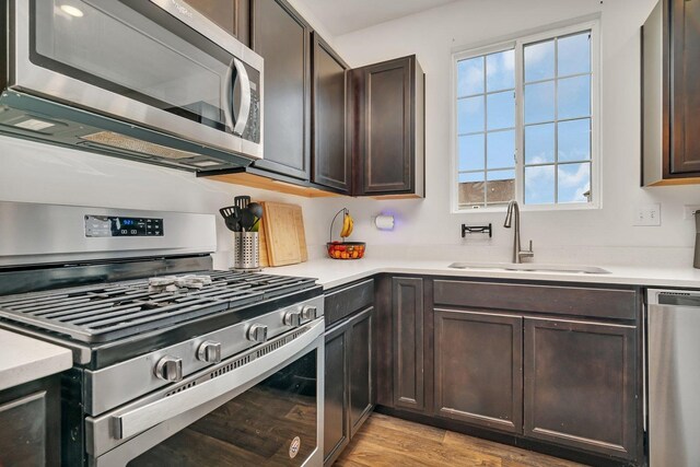 1825 Spencer Way, Shorewood, IL 60404 - kitchen with dark brown cabinets, light countertops, stainless steel appliances, and a sink