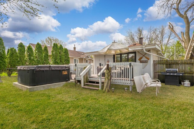 26312 W Blackhawk Ave, Ingleside, IL 60041 - back of house featuring a hot tub, fence, a yard, a wooden deck, and a chimney