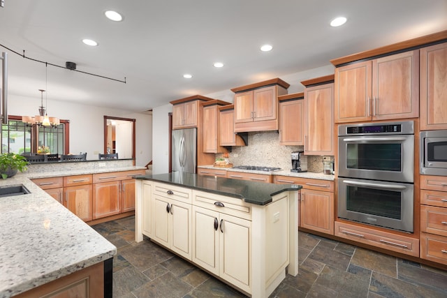 kitchen with recessed lighting, appliances with stainless steel finishes, tasteful backsplash, and stone tile flooring
