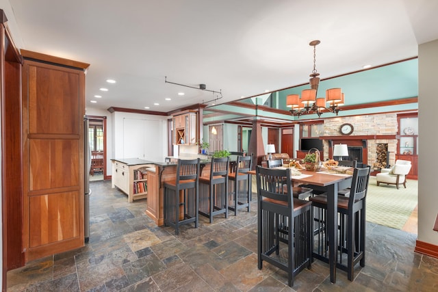 dining space with stone tile floors, recessed lighting, and a notable chandelier