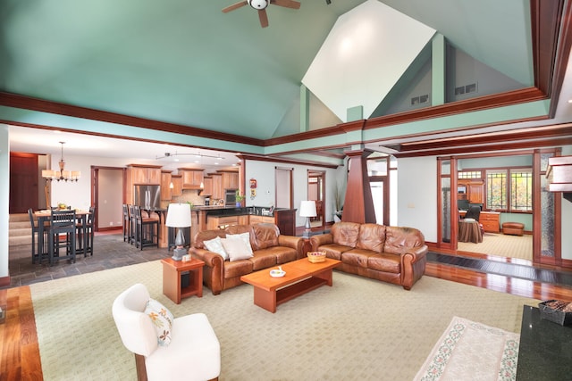 living area with crown molding, baseboards, ceiling fan with notable chandelier, and lofted ceiling