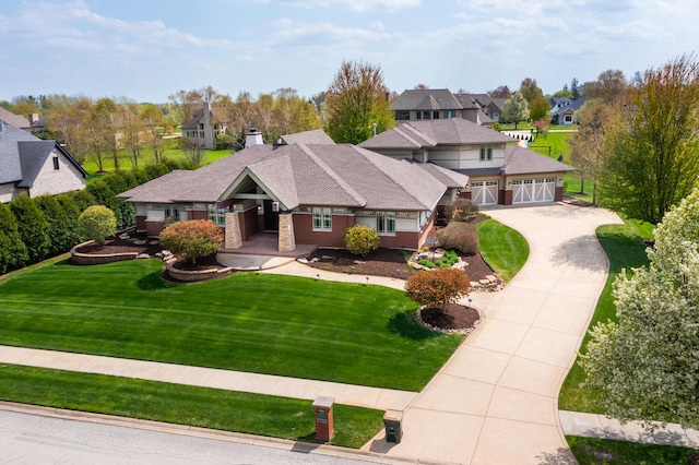 prairie-style home featuring a residential view, driveway, a chimney, and a front lawn