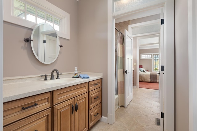 full bath featuring a shower with curtain, tile patterned floors, baseboards, and vanity