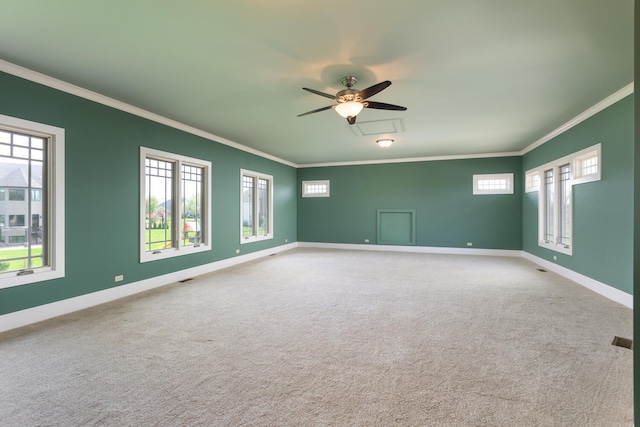 unfurnished room with baseboards, ornamental molding, and carpet