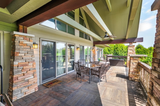 view of patio / terrace featuring a ceiling fan, a wooden deck, and outdoor dining space