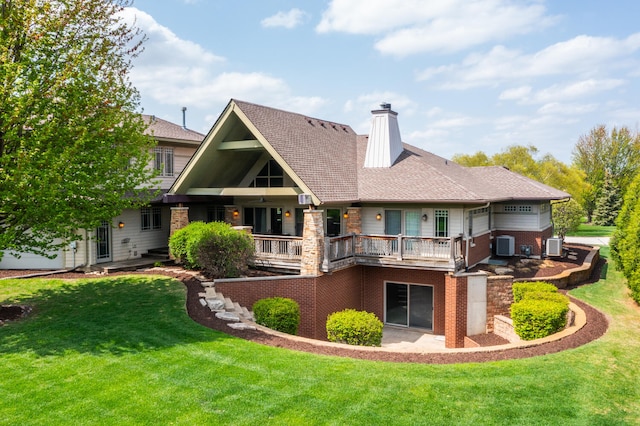 back of property with ceiling fan, central air condition unit, a yard, and a chimney