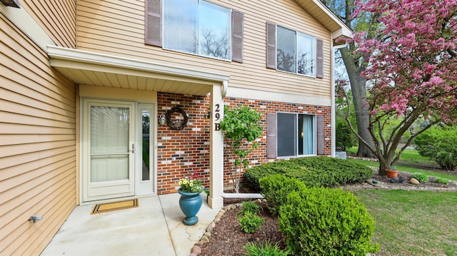 property entrance featuring brick siding
