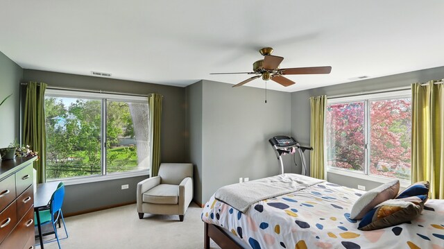 bedroom featuring carpet flooring, visible vents, and multiple windows