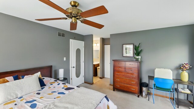 bedroom with ensuite bathroom, light carpet, a ceiling fan, and visible vents