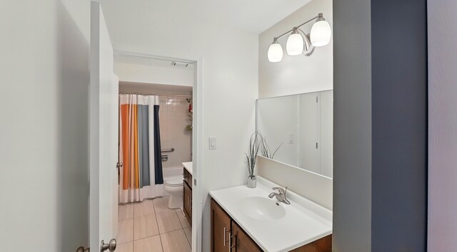 bathroom featuring vanity, tile patterned flooring, and toilet
