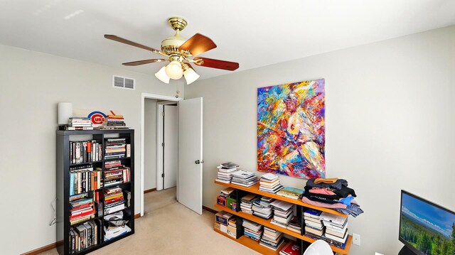 interior space featuring a ceiling fan, visible vents, and light carpet
