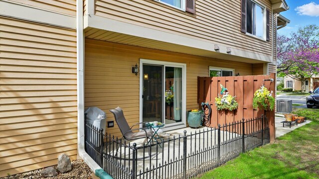 exterior space featuring central air condition unit and fence