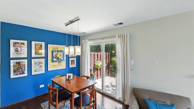 dining space featuring visible vents and dark wood finished floors
