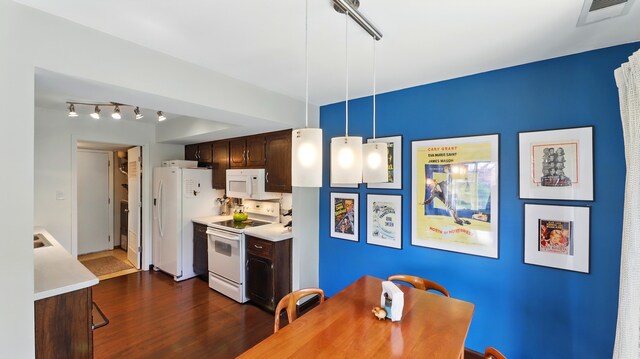 kitchen with light countertops, dark brown cabinetry, white appliances, and visible vents