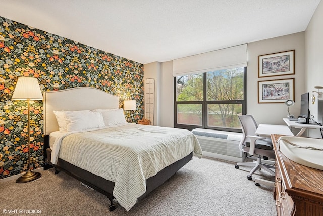 901 S Plymouth Ct Unit 104, Chicago, IL 60605 - bedroom with carpet, wallpapered walls, a desk, an accent wall, and a wall mounted air conditioner