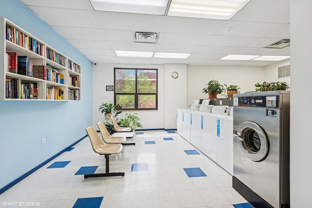 901 S Plymouth Ct Unit 104, Chicago, IL 60605 - shared laundry room featuring washer and dryer, tile patterned floors, and baseboards