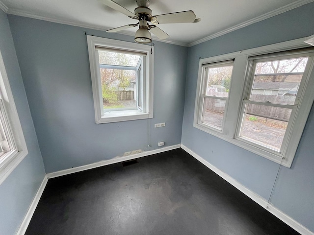spare room with crown molding, baseboards, a ceiling fan, and visible vents
