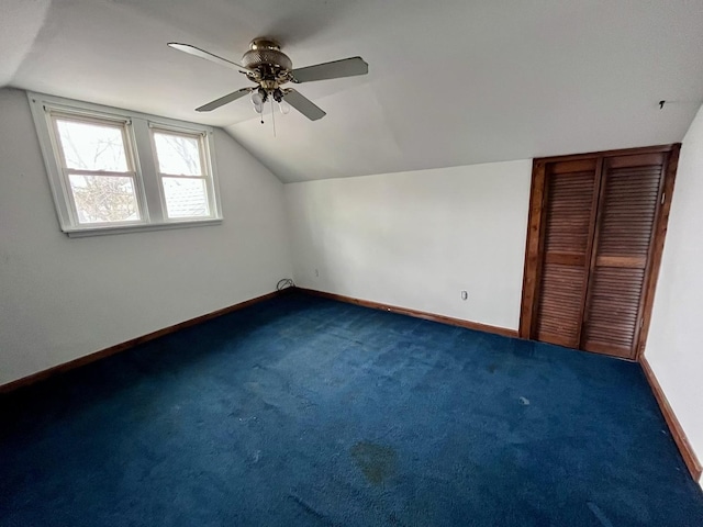 additional living space featuring a ceiling fan, baseboards, and lofted ceiling
