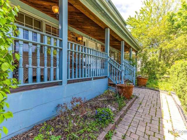 view of home's exterior featuring covered porch and stairway