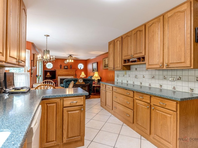 kitchen with light tile patterned floors, open floor plan, a ceiling fan, backsplash, and crown molding