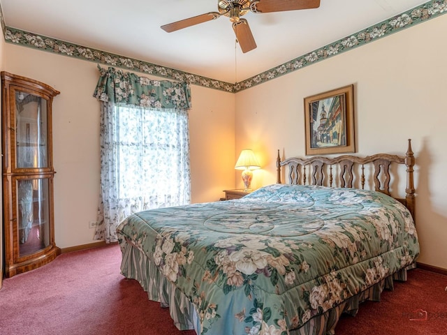 carpeted bedroom featuring baseboards and a ceiling fan