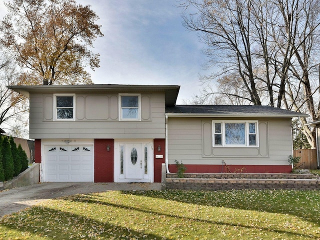 7260 Rosewood St, Hanover Park, IL 60133 - split level home with an attached garage, driveway, a front lawn, and brick siding