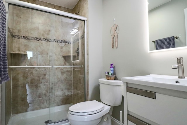 full bath featuring toilet, a stall shower, and vanity