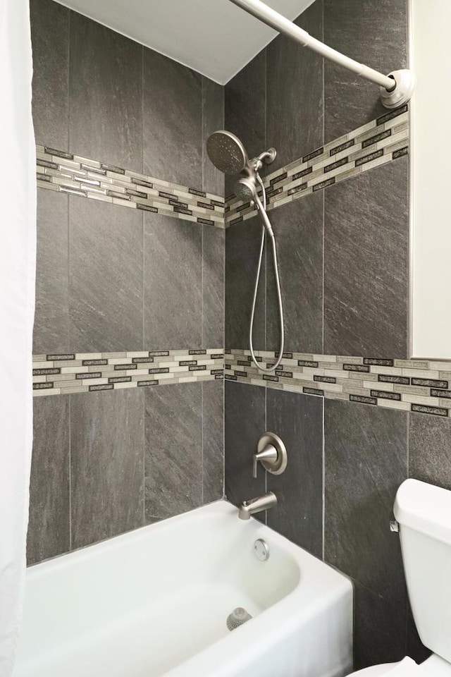 bathroom with toilet and shower / tub combo