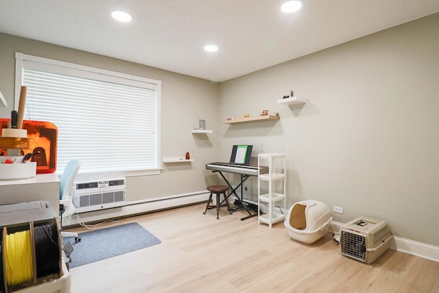 office space featuring recessed lighting, baseboards, a wall unit AC, wood finished floors, and a baseboard radiator