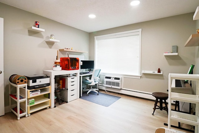 home office featuring baseboard heating, a wall mounted AC, recessed lighting, and wood finished floors