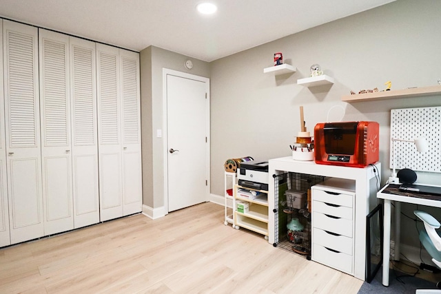 office area featuring light wood-style floors, baseboards, and recessed lighting