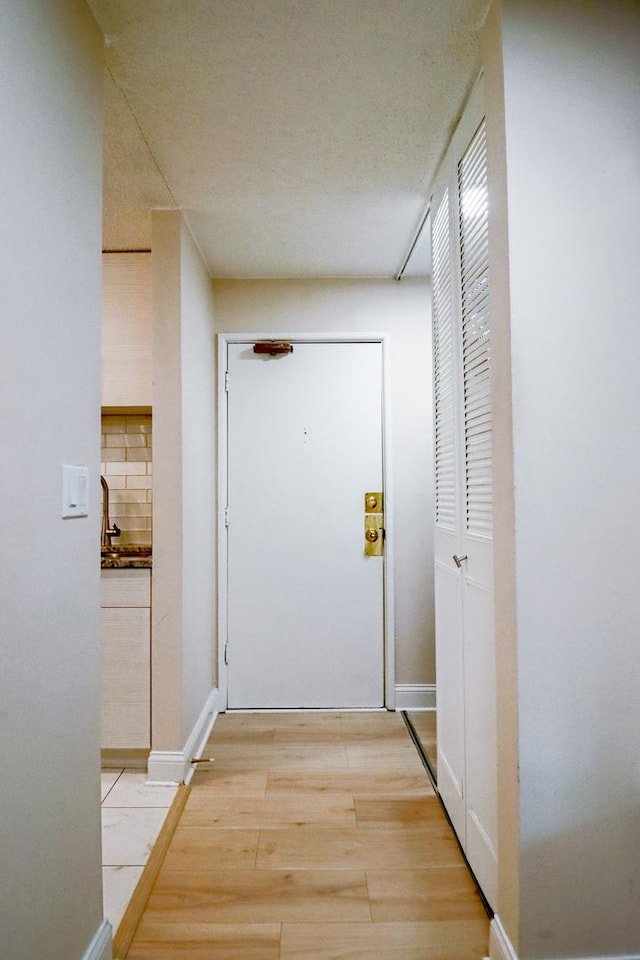 corridor with light wood finished floors