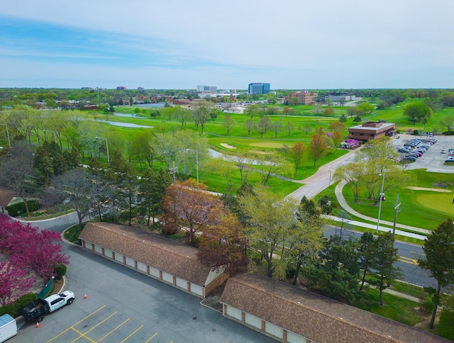 drone / aerial view with a water view and view of golf course