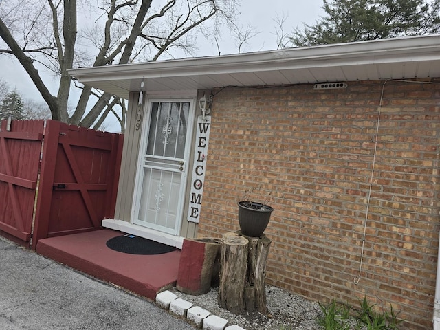 3109 Sussex Ave, Markham, IL 60428 - view of exterior entry with brick siding, fence, and a gate