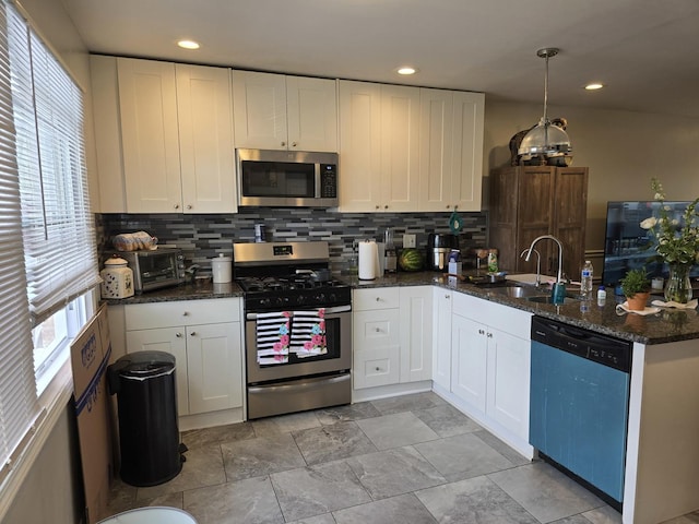 3109 Sussex Ave, Markham, IL 60428 - kitchen featuring appliances with stainless steel finishes, tasteful backsplash, a sink, white cabinets, and a peninsula