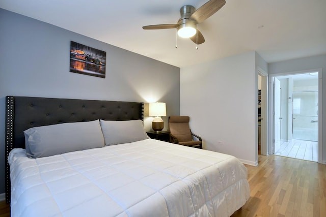 bedroom featuring a ceiling fan, baseboards, and wood finished floors