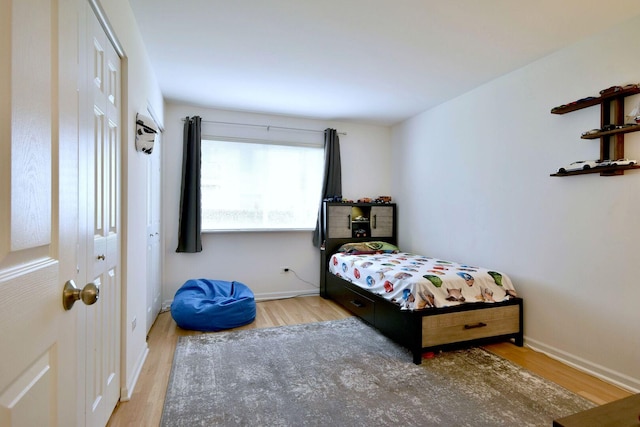 bedroom featuring baseboards and wood finished floors